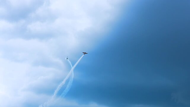 Sports planes that perform aerobatic stunts and leave smoke trails.
