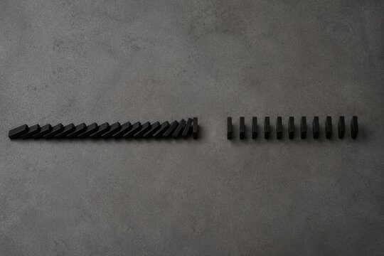 Chain of dominoes with one missing piece, halting the cascade from above.