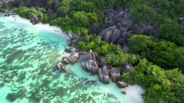 Aerial view of turquoise water and massive granite rocks at la digue.