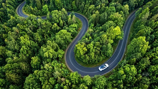 Aerial view of a white car driving on a winding forest road abstract background with flowing shapes and lines