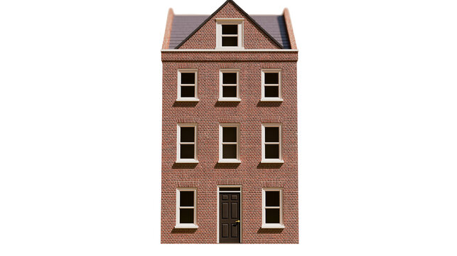Terraced brick house with pitched roof and dormer window