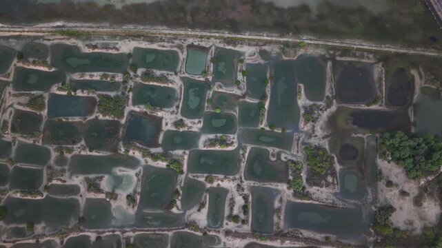 Top Down Drone Flight Over Geometric Water Ponds Creating Abstract Landscape Pattern