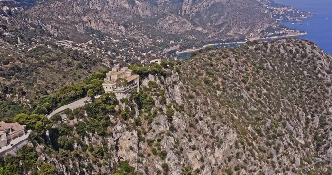 Villefranche sur Mer France Aerial v2 establishing pan shot spectacular view of the very few homes that perched on rocky clifftop at plateau saint michel - July 2021