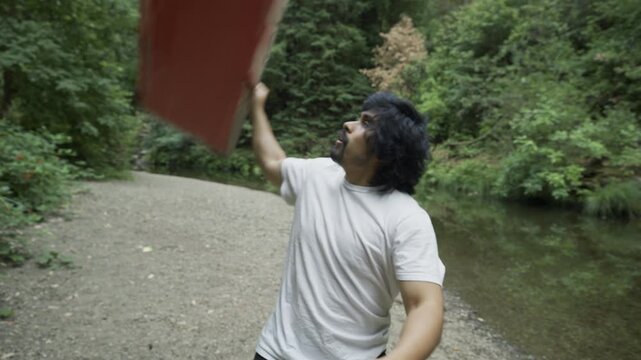 Happy Man Spinning Red Board Around Him - Close-Up