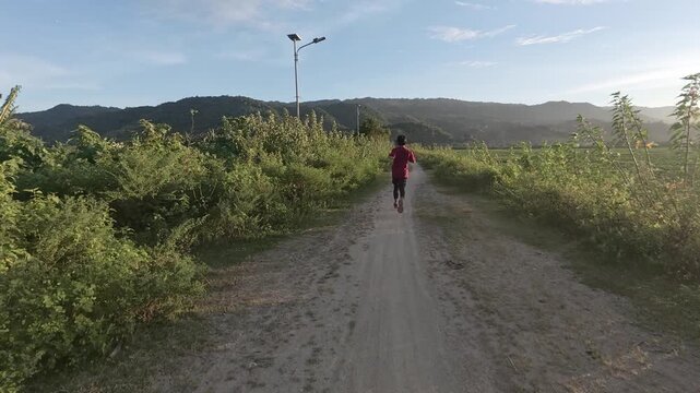 Person Running on a Path During Sunset