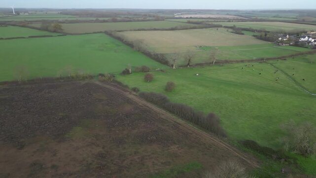 Aerial Drone View of English Village and Patchwork Pasture Fields in Northamptonshire Countryside