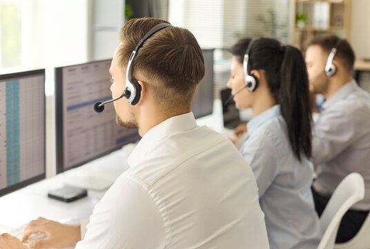 Callcenter operators with headsets provide customer support. Professionals manage calls, resolve tickets and help clients in a bright office. Clear teamwork, communication, and service concept.