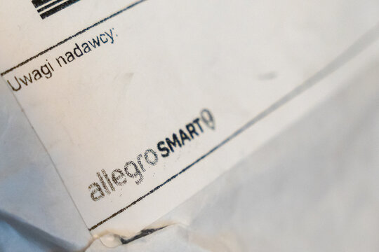 Warsaw, Poland - July 5, 2026: Handwritten note on white paper featuring delivery instructions and information about allegroSMART service, conveying a sense of personal communication.