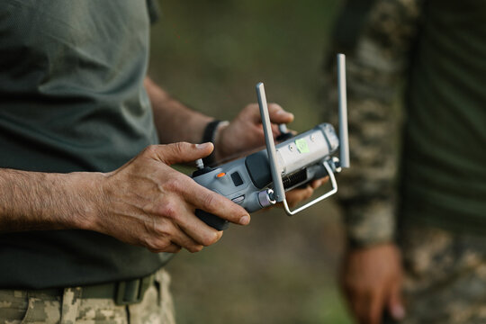 Ukrainian military personnel operating reconnaissance drone controller learning to fly uav