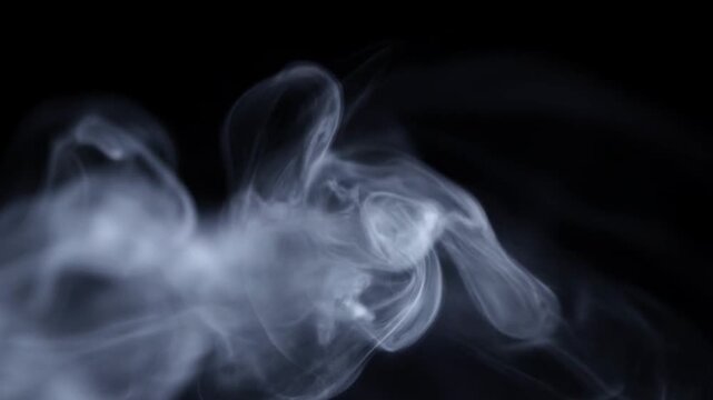 Ethereal white smoke swirling against a deep black background, creating abstract fluid patterns of vapor and mist
