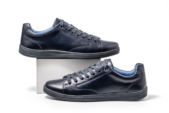 Black leather sneakers. Sport shoes isolated on white background, clipping path included