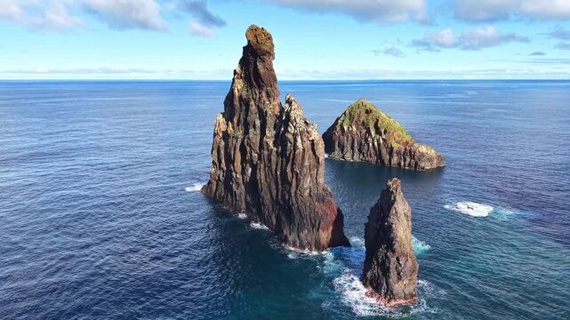Cinematic drone orbit around the iconic volcanic sea stack at Ribeira da Janela, Madeira, Portugal
