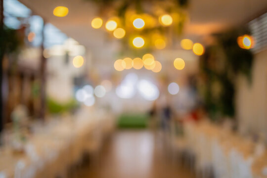 Vintage tone blur image of food stall at night festival with bokeh for background usage. Festival Event Party with People Blurred Background. Blur people having sunset beach party in summer vacation