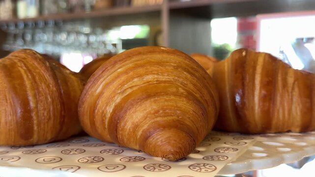 Freshly baked croissants displayed in a bakery window