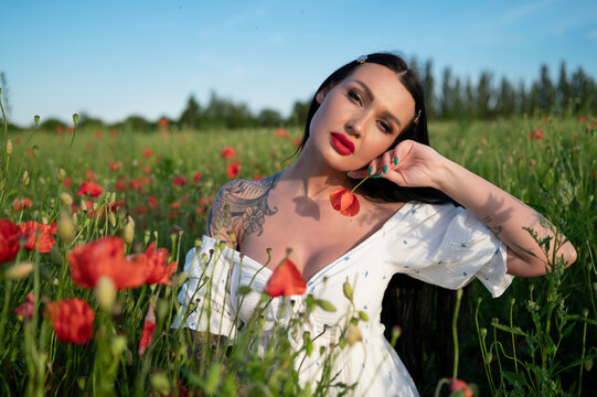 young woman white dress  in poppy field