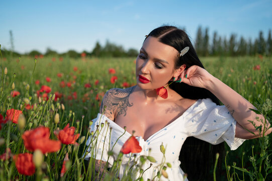 young woman white dress  in poppy field