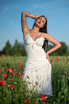 young woman white dress  in poppy field
