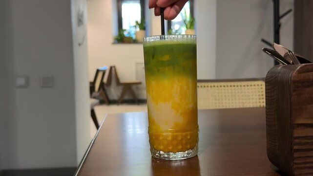 matcha drink Fresh mango smoothie in glass with mint garnish, tropical fruit shake on wooden background, healthy yellow mango lassi for summer wellness