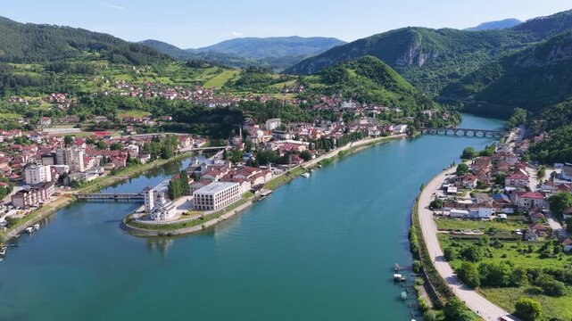 Visegrad, Bosnia and Herzegovina &ndash; May 30, 2026: Elevated drone panorama showing Andricgrad, the Drina River and surrounding mountain landscape