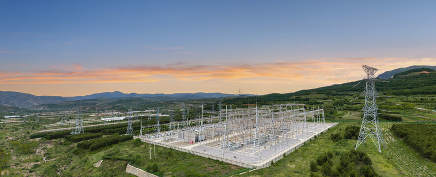 Ultra-Large Substation at Dawn with Integrated Energy Storage and Mountainous Landscape