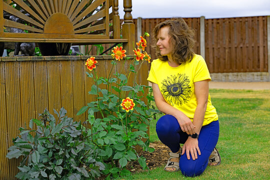 Lady with her Pooh Dahlias.