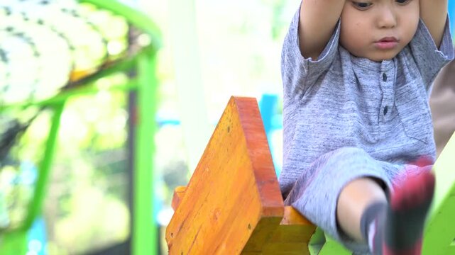 Child playing with colorful foam soap bubbles in outdoor garden setting with joyful expression