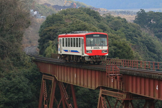 A Minamiaso Railway train crossing a steel trestle bridge on February 4, 2015 in Minamiaso, Kumamoto, Japan.