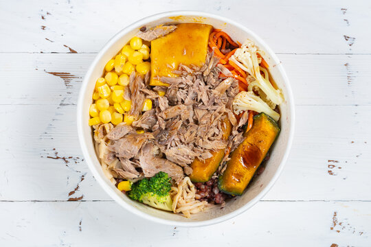 Warm tuna grain bowl topped with tender shredded deep-sea tuna, assorted roasted vegetables and glossy Japanese vinaigrette sauce