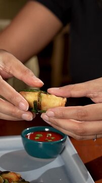 Hands Breaking Crispy Vegetable Spring Roll Video Showing Filling