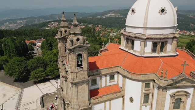 Aerial view of the Sanctuary of Our Lady of Sameiro with its white dome and stone bell towers set against the surrounding hills in Braga, Braga, Portugal.