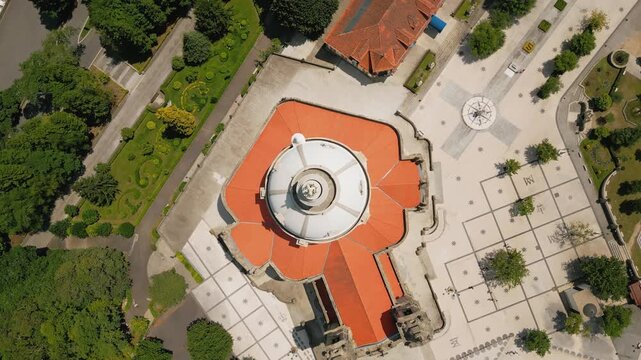 Aerial view of the Sanctuary of Our Lady of Sameiro with its distinctive white dome and orange roof surrounded by paved plazas and lush gardens in Braga, Braga, Portugal.