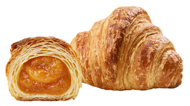 Flaky golden croissant filled with apricot jam, close-up