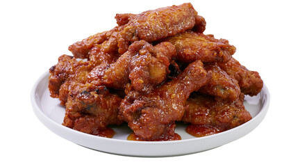 Spicy glazed chicken wings piled on white plate © Vetle