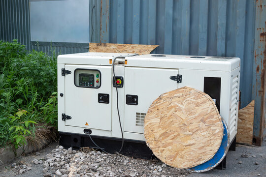White industrial diesel power generator installed outdoors