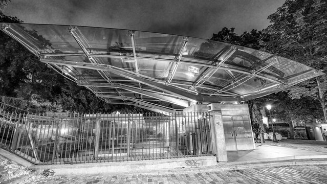 Night view of Montmartre funicular glowing in Paris.