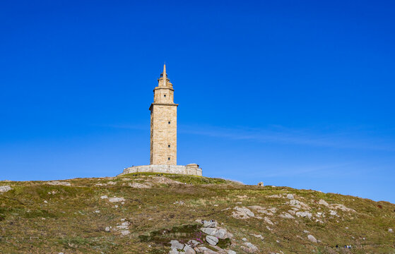 Ancient Tower of Hercules Roman lighthouse in A Coru&ntilde;a under blue sky