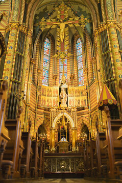 Sittard historic church interior with ornate golden altar, large crucifix, stained glass windows and detailed gothic architectural heritage in Netherlands