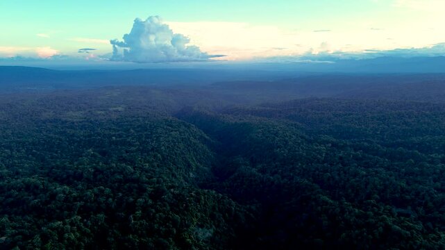 Sunset Over Vast Tropical Rainforest in Ecuador with Blue Mountain Ridges, Dramatic Clouds and Remote Andean Amazon Wilderness Landscape
