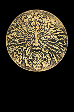 Green Man symbol gold plaque nature tree spirit decoration on black background. Nature figure symbol of rebirth in medieval folklore, cycle of life concept. Not copyrighted. 