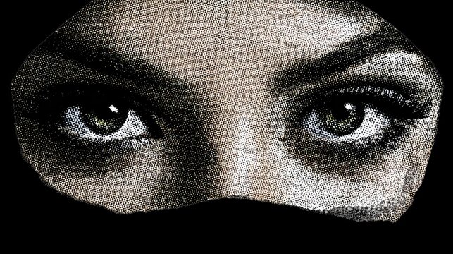 Mysterious Gaze: A close-up shot focusing on a woman's intense, kohl-lined eyes and dark hijab, hinting at mystery and unspoken stories.