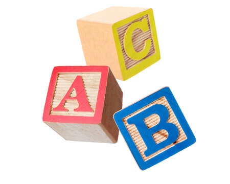 Wooden cubes with letters flying in air against transparent background