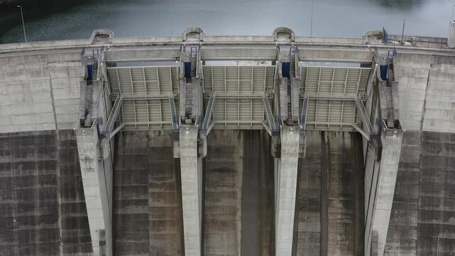 Aerial view of the concrete structure of Ribeiradio Dam with its massive spillway gates and vertical buttresses in Sever do Vouga, Aveiro District, Portugal.