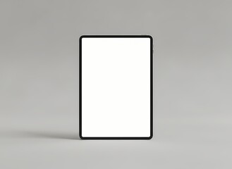Fototapeta premium A digital tablet device with a blank illuminated screen stands upright on a neutral-colored flat surface, ready for interactive content or application display