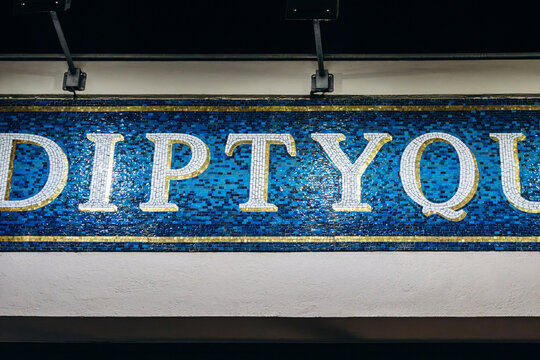 Berlin, Germany - April 22, 2026: Diptyque mosaic logo sign displayed above the entrance of a Diptyque boutique in central Berlin