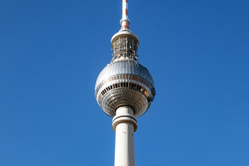 Berlin, Germany - April 22, 2026: Close-up views of the Berlin TV Tower (Fernsehturm) observation sphere and antenna against a clear blue sky at Alexanderplatz © Andrei Antipov