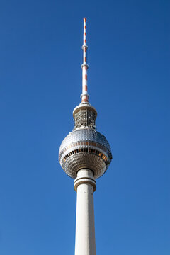 Berlin, Germany - April 22, 2026: Close-up views of the Berlin TV Tower (Fernsehturm) observation sphere and antenna against a clear blue sky at Alexanderplatz
