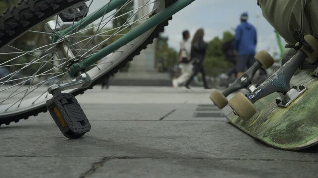 Bicycle Wheel and Skateboard In Extreme Close-Up Ground Level At San Francisco Plaza