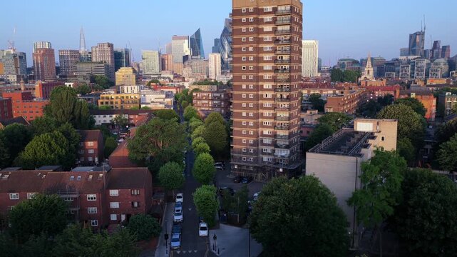 Aerial Video Reveal of London City Skyline featuring East London Council Tower Block at Sunrise.