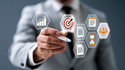 Obraz premium A businessman in a suit uses a pen to interact with floating digital icons representing growth, targets, calendars, documents, and teamwork.