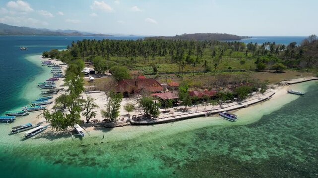 Aerial drone view Gili Sudak Indonesia sunny day featuring white sand beach turquoise lagoon tropical paradise island landscape